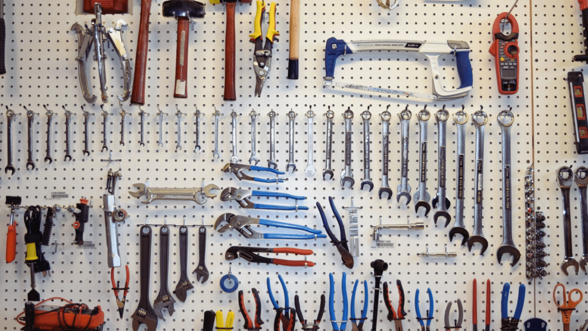 garage pegboard with tools and extension cords hanging home organization