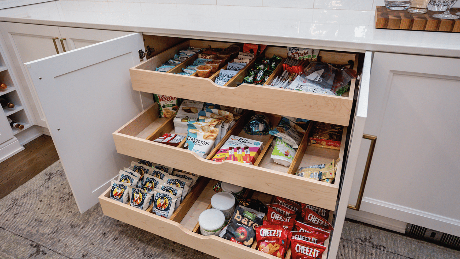 organized snack cabinet with baskets and treats home organization