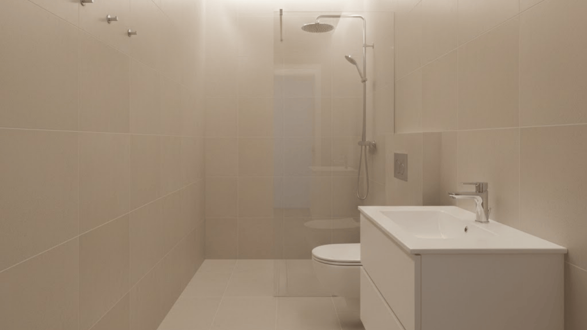 toilet centered on the long wall with shower at the end