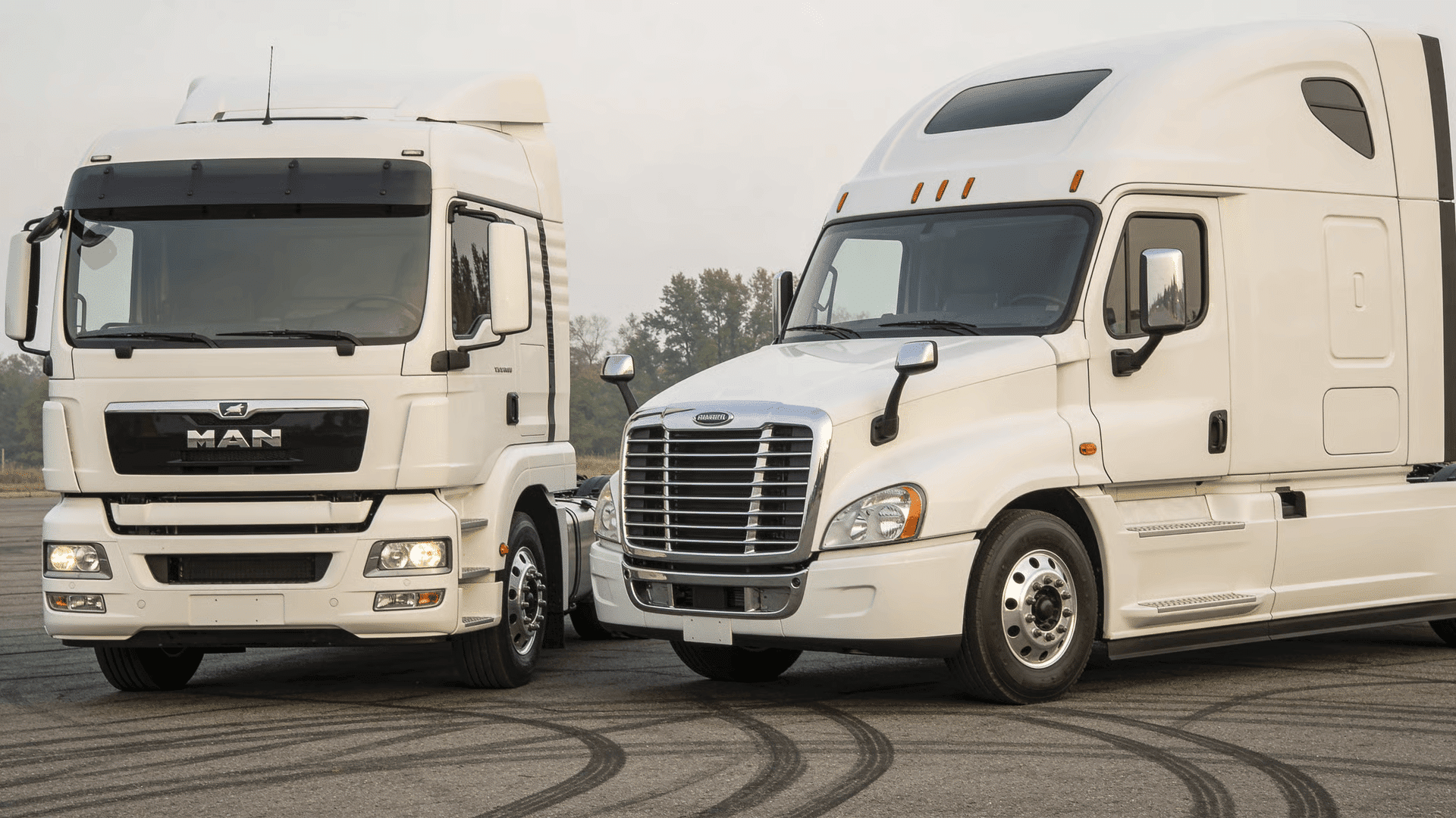 Cabover truck next to long-hood truck showing shorter front length and cab position