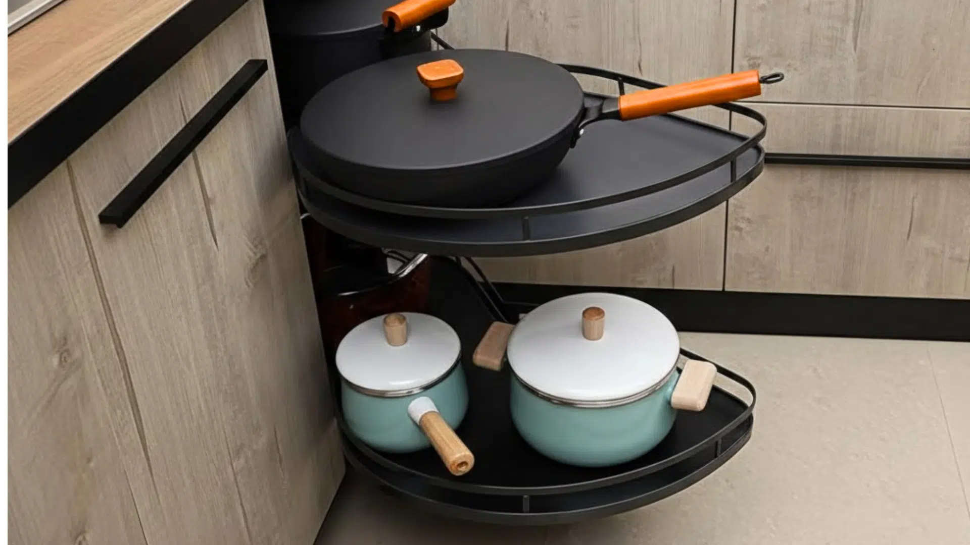 blind corner cabinet with swing out trays holding pots and lids pulled forward for easy access