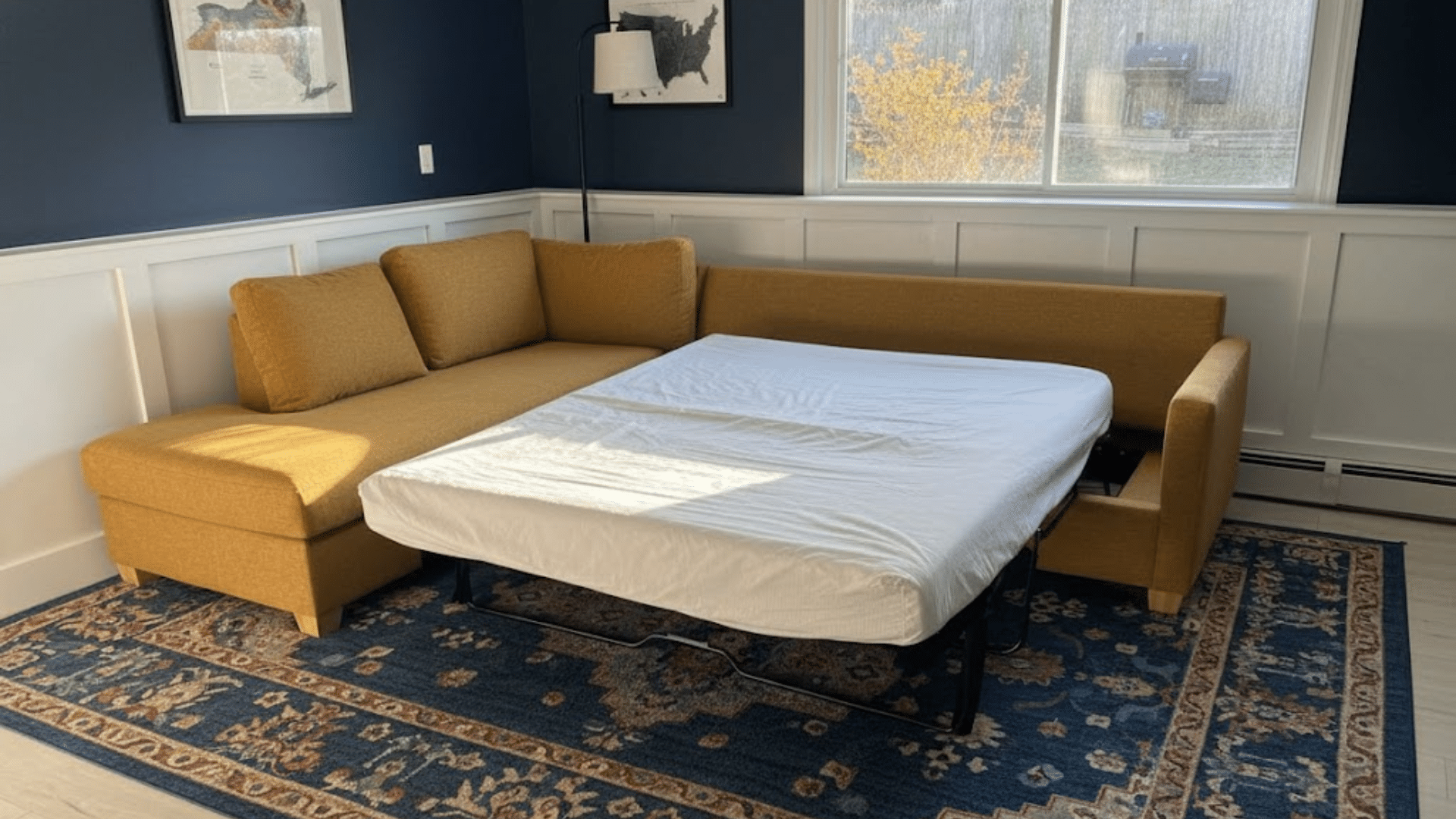 sectional sleeper sofa with pull-out bed and chaise in a spacious family living room with neutral colors