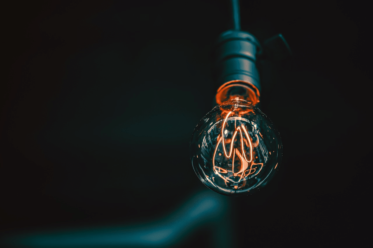 A light bulb with a light filament
AI-generated content may be incorrect.