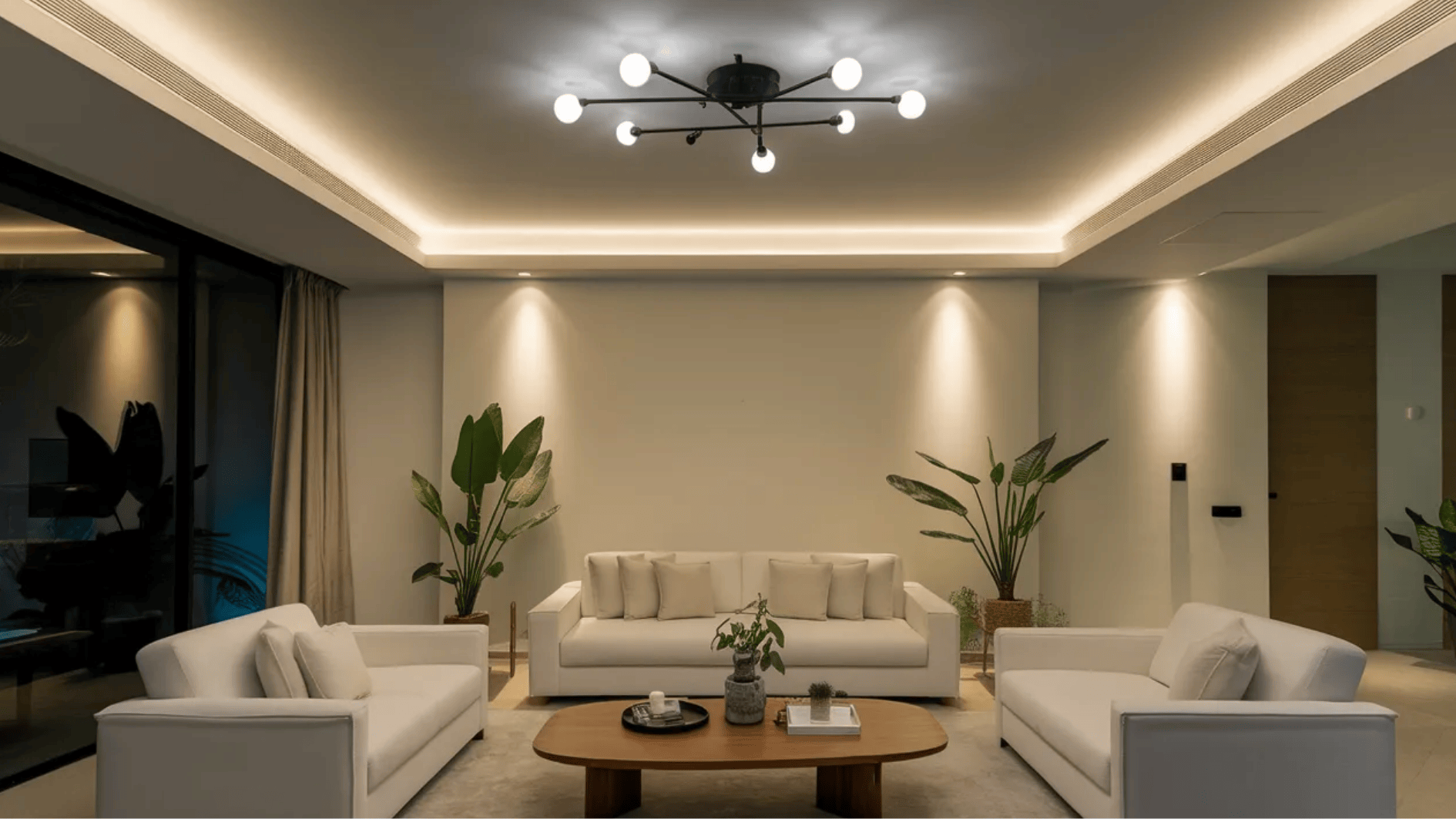 a modern living room equipped with smart lighting with sofa and a table in the centre of the room