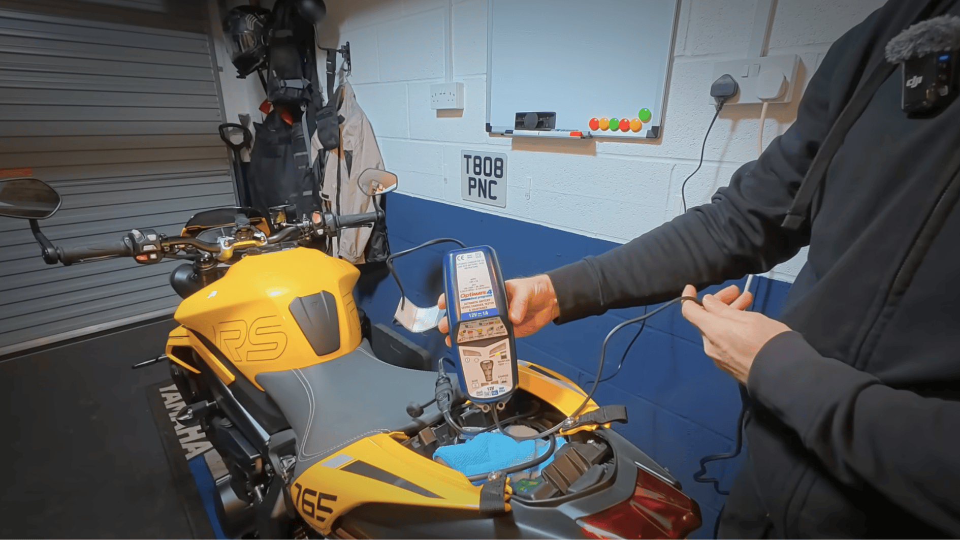 battery charger connected to motorcycle during winter storage to maintain charge and prevent battery damage