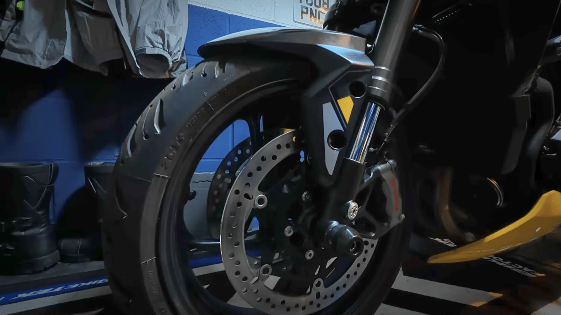 front wheel and brake disc of motorcycle cleaned and inspected before long-term winter storage indoors