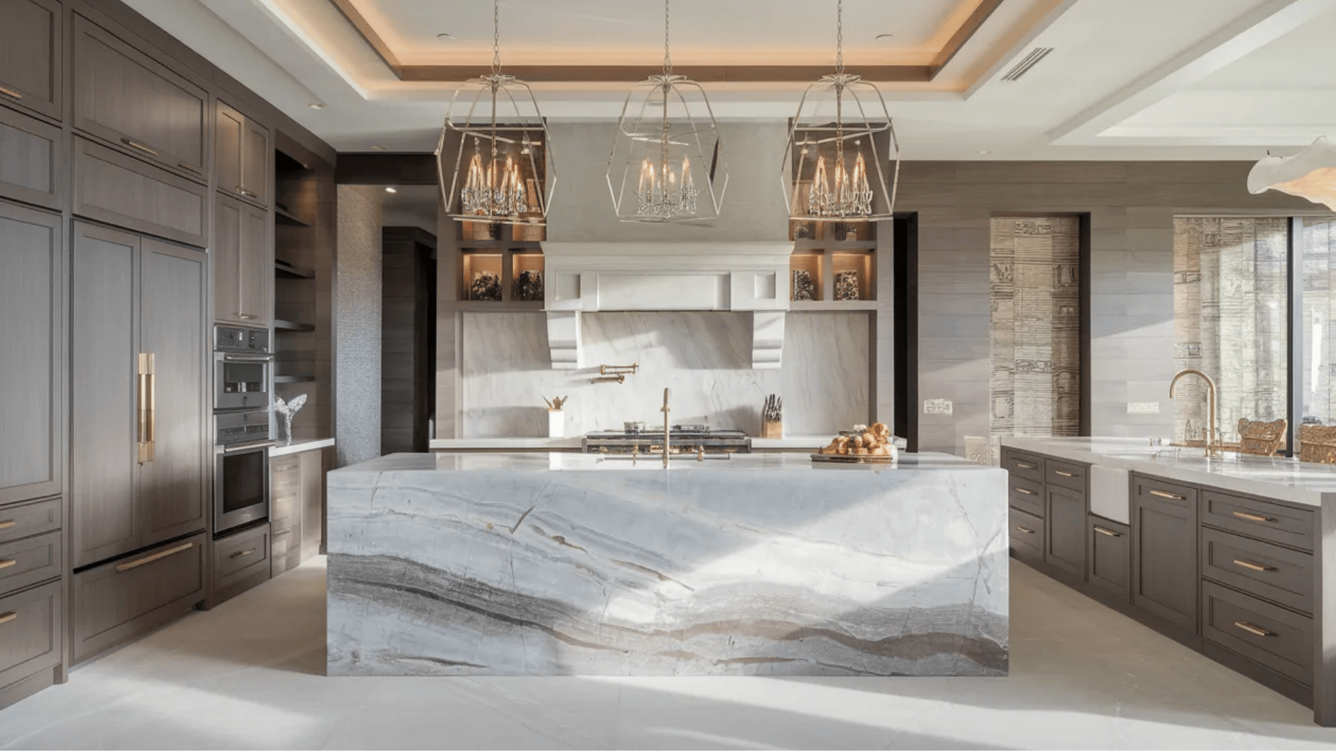 high-end luxury kitchen remodel with large marble waterfall island, custom cabinets, designer lighting and premium appliances