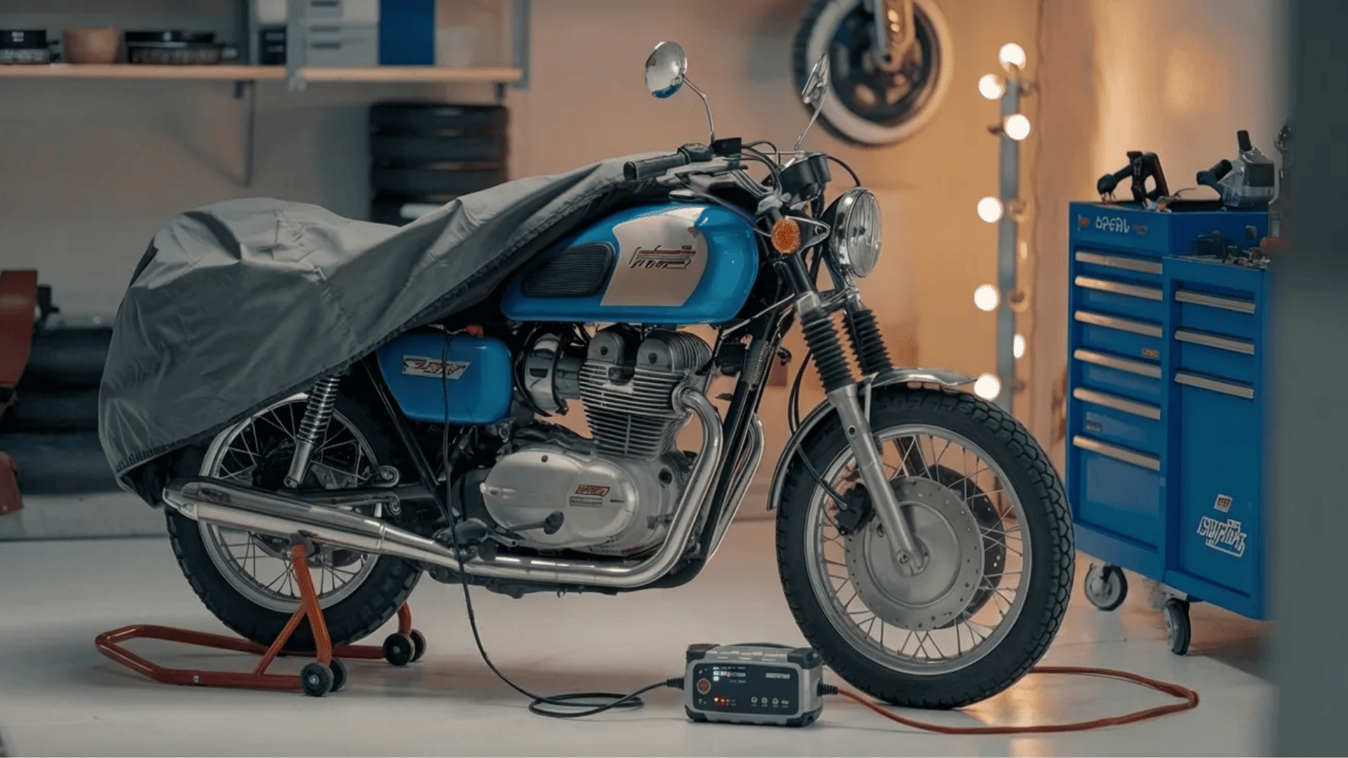 motorcycle covered in garage with battery charger connected, prepared for safe winter storage and long-term protection