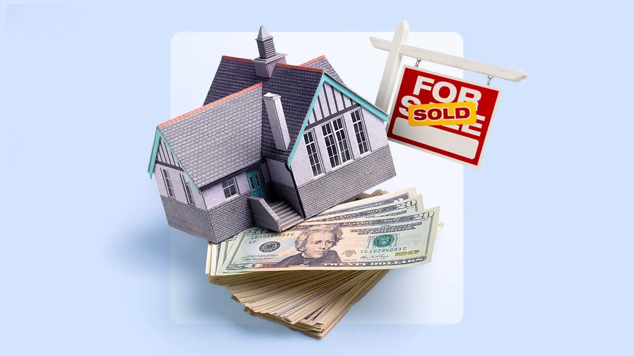 Model house atop stack of cash with sold sign against light blue background