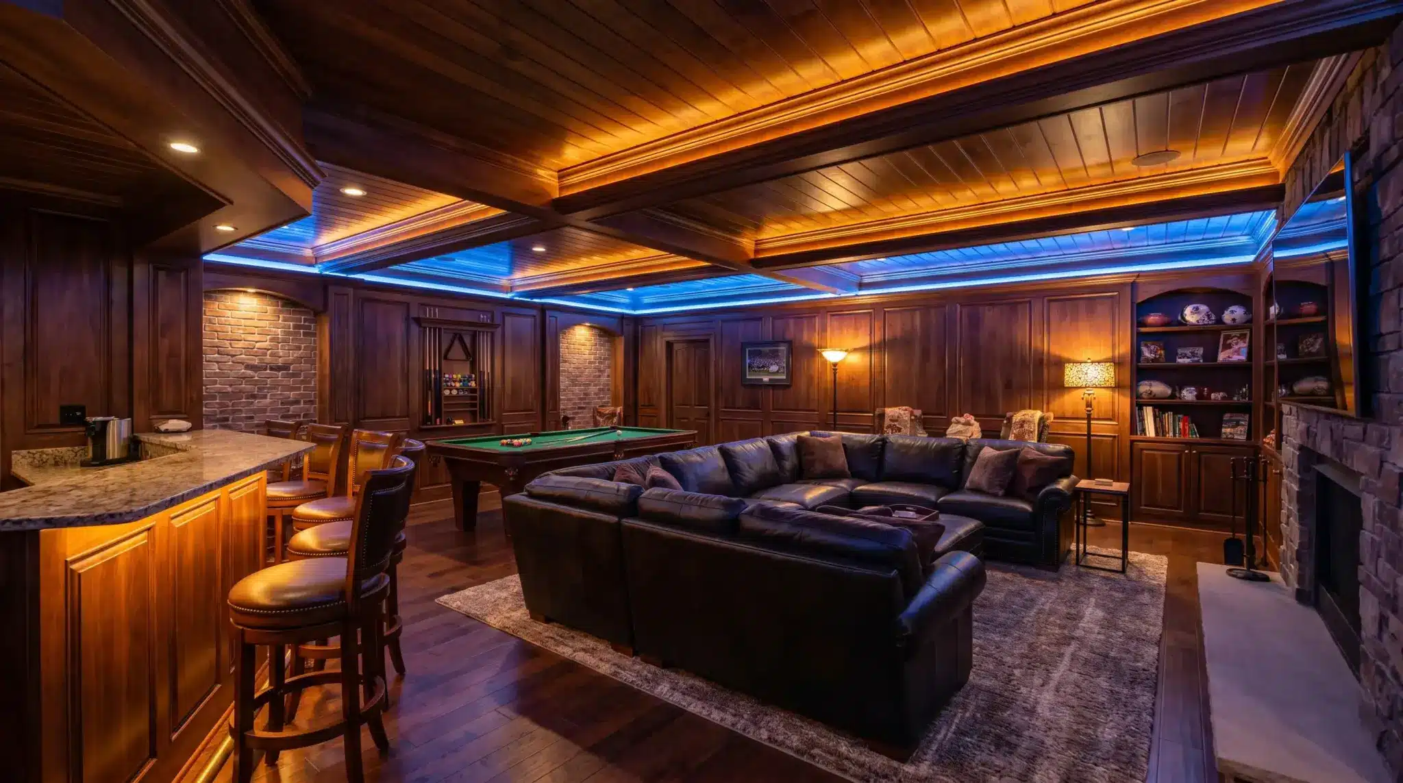 Luxurious home theater room with leather sectional, pool table, and dim mood lighting in wood-paneled setting