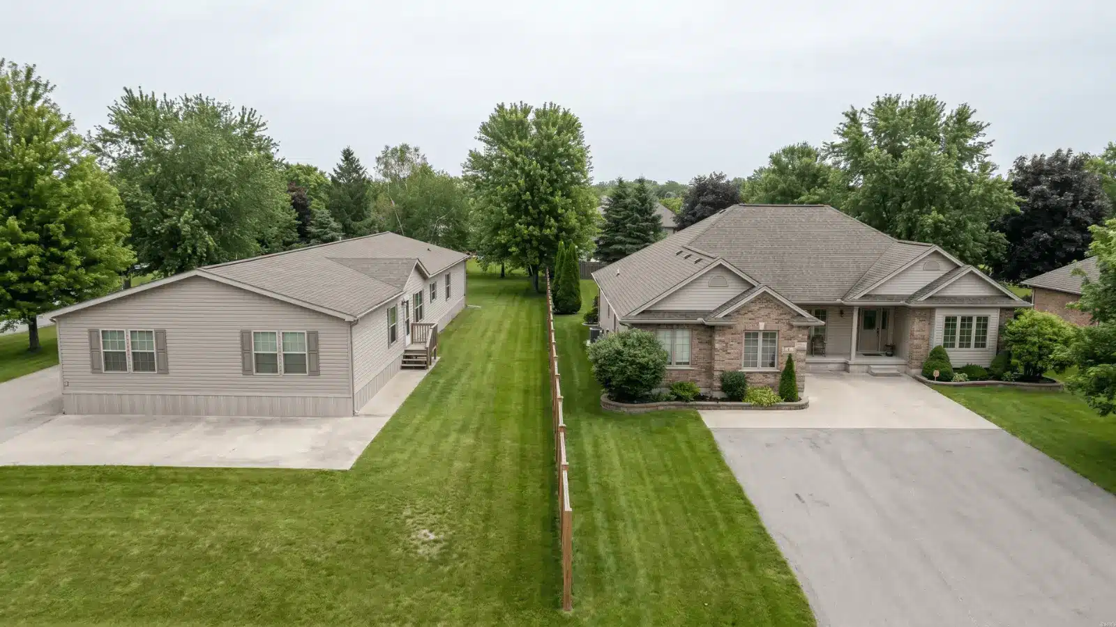 Two large single-story homes on separate plots showing different construction styles and layouts