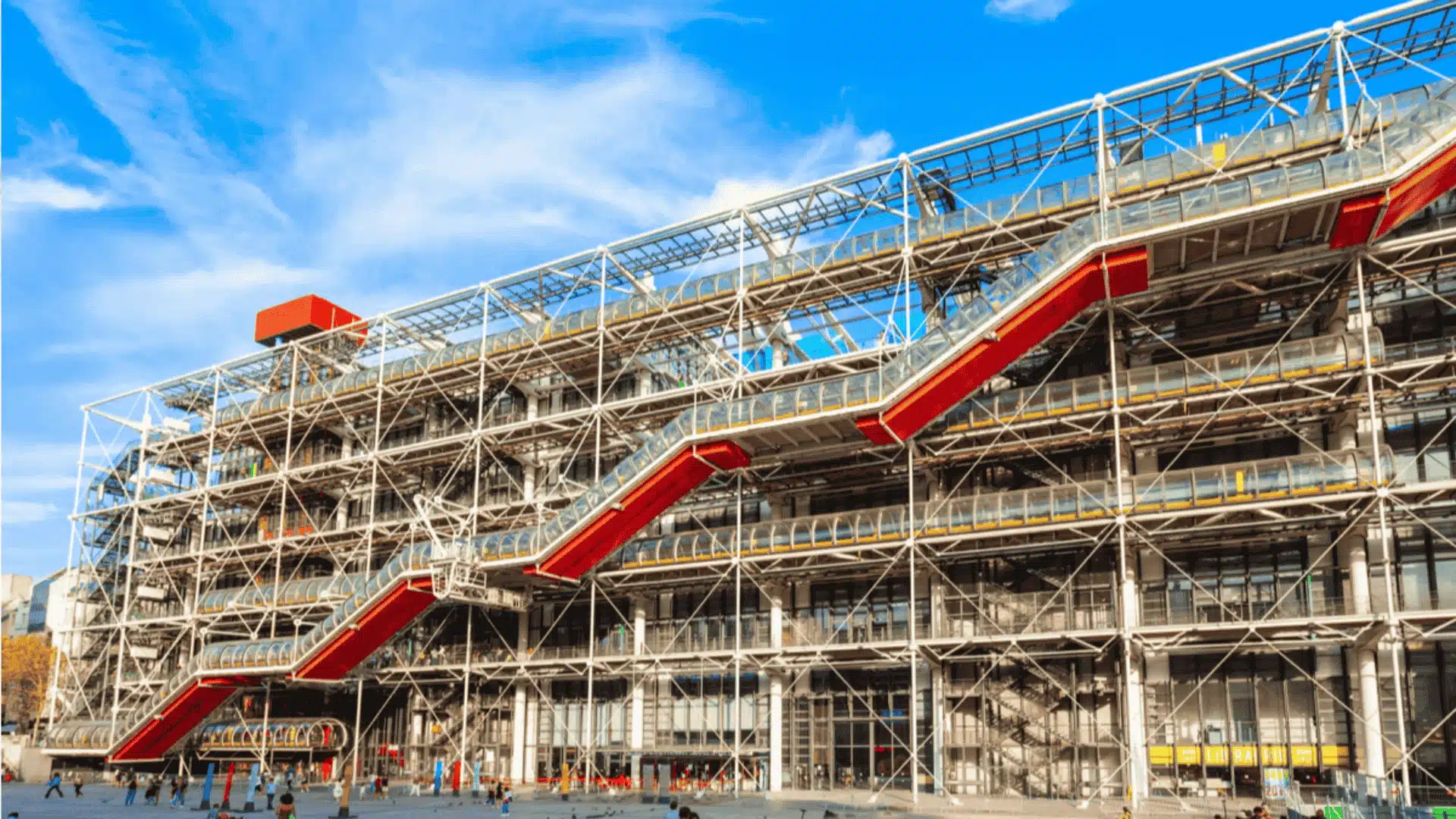 Centre Pompidou in Paris, with its exposed structural framework and colorful escalators against a bright blue sky.