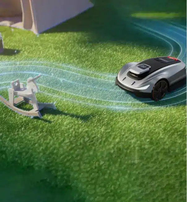 Robotic lawn mower operating on grass near a wooden rocking horse under sunlight