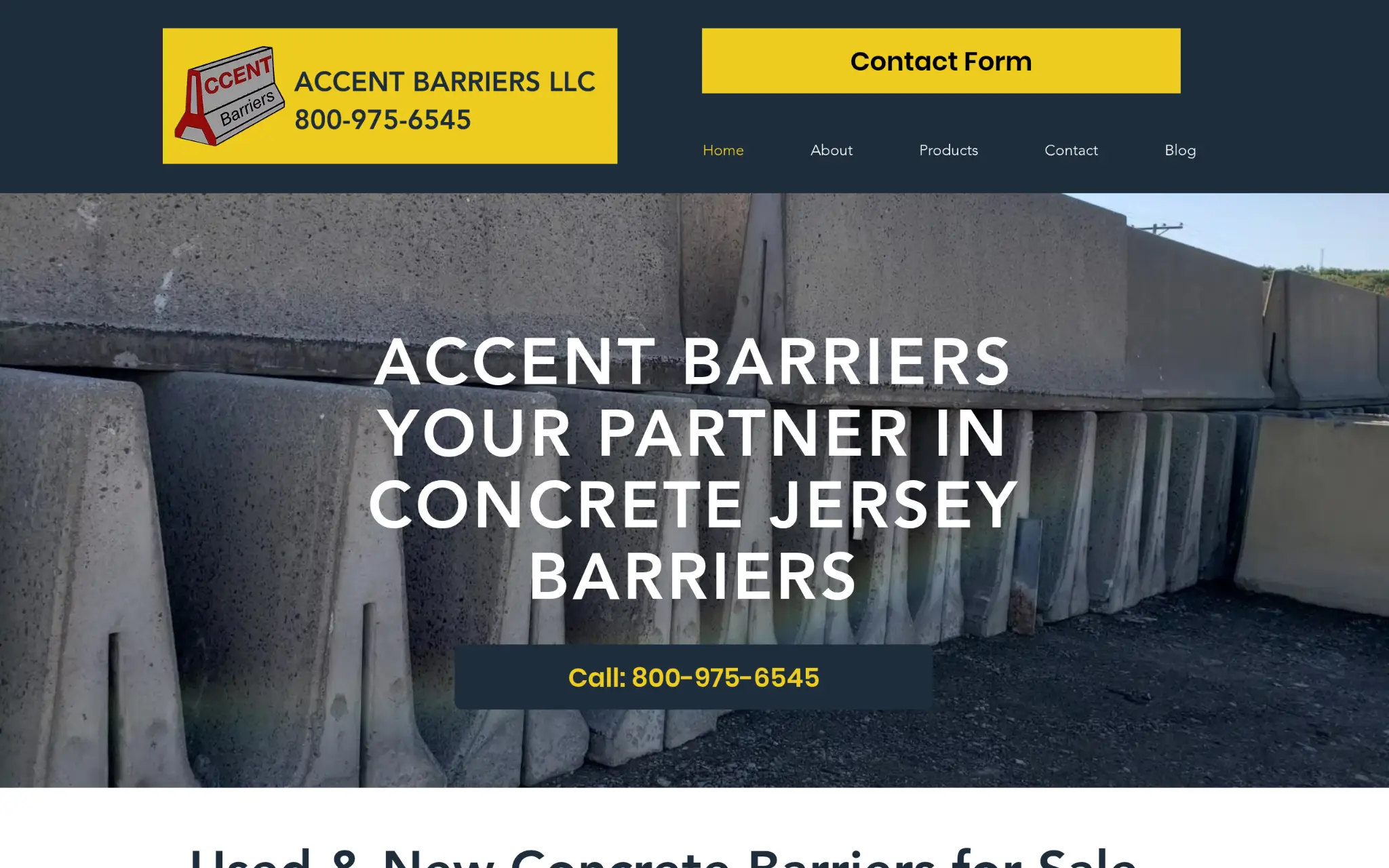 Concrete barriers stacked outdoors against blue sky in a commercial setting