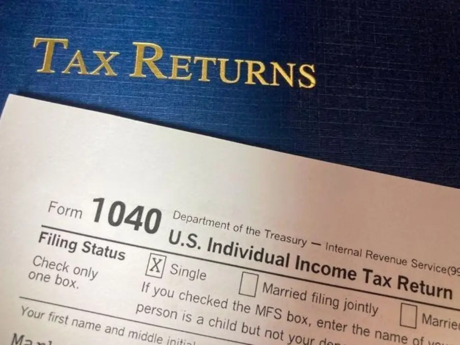 Form 1040 U.S. Individual Income Tax Return document on blue background