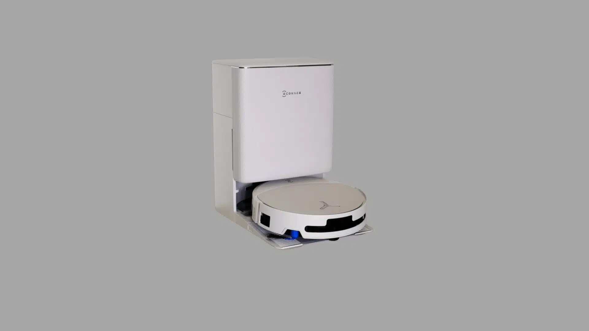 White robot vacuum with charging dock placed on a tiled floor in a home interior.
