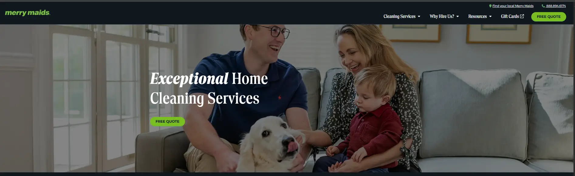 Family sitting on a couch in a bright living room with a dog