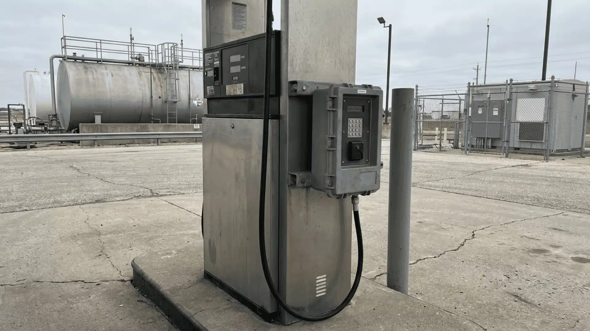 Fuel dispenser with access control panel at a private fleet fueling station on a concrete pad