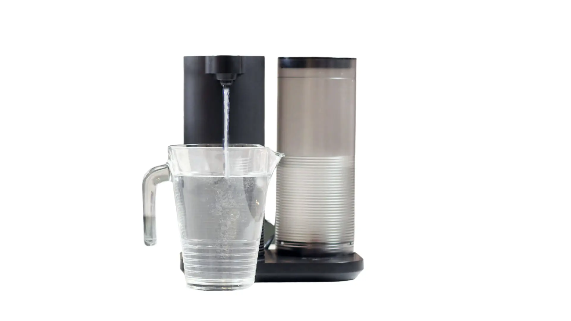 Aquasana Clean Water Machine dispensing filtered water into a clear pitcher on a kitchen countertop