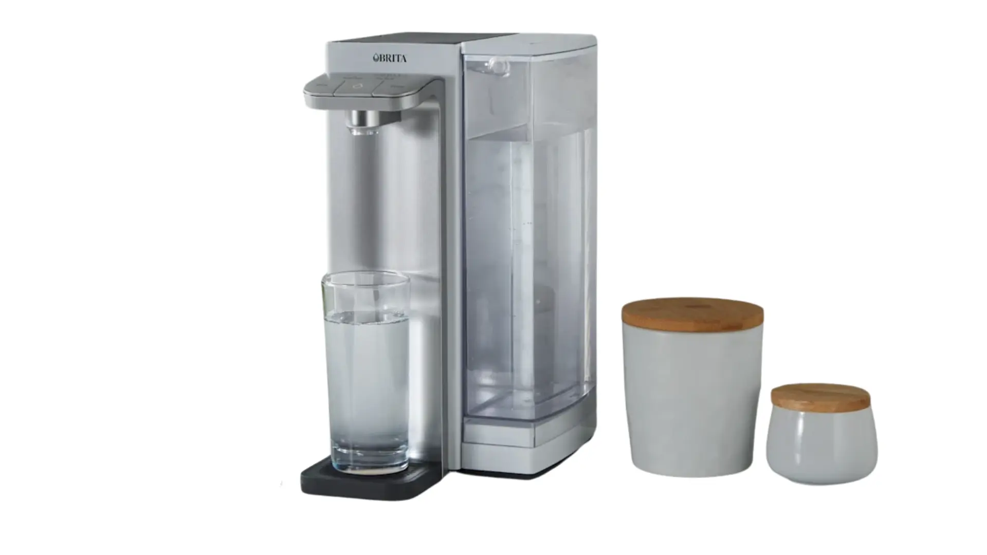 Brita Hub countertop water filtration system with clear reservoir and a glass positioned under the dispenser