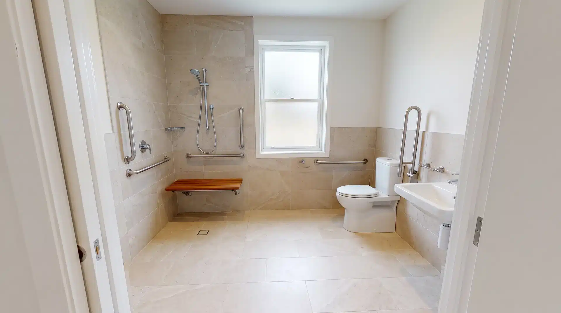 ccessible bathroom with grab bars, shower seat, and safety features