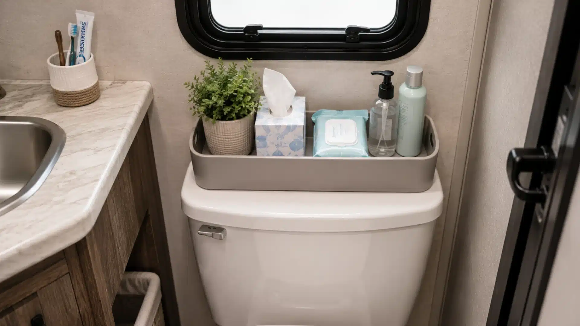 Compact storage tray holds tissues, wipes, and toiletries above an RV bathroom toilet