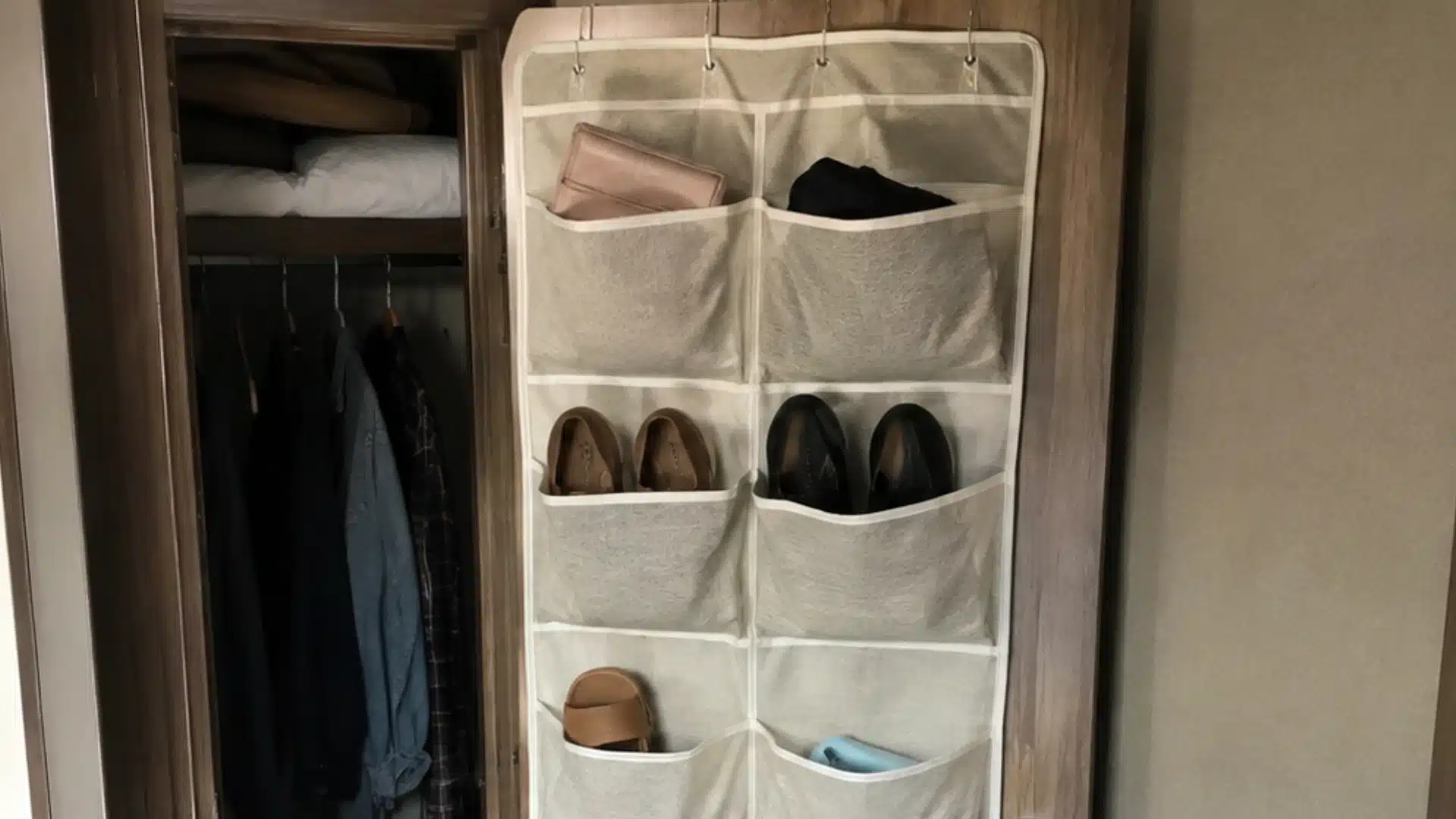 Fabric shoe organizer hanging over an rv closet door with shoes