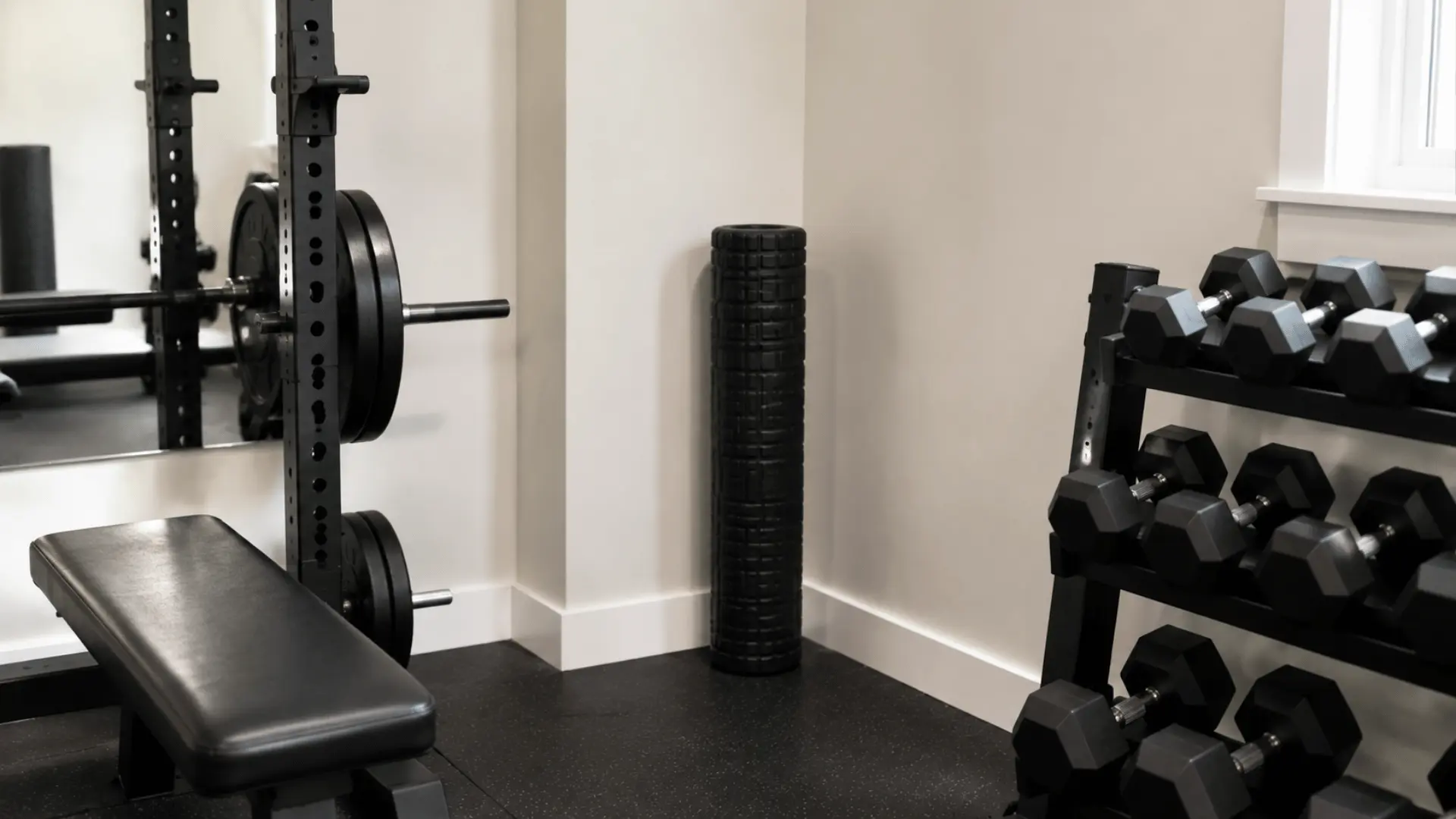 Foam roller standing upright in the corner of a home gym