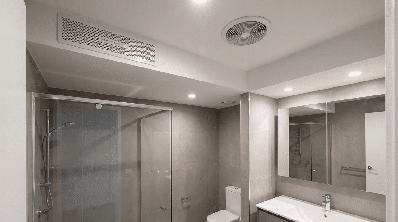 Full bathroom with a built-in scent diffuser system positioned apart from the exhaust vent.