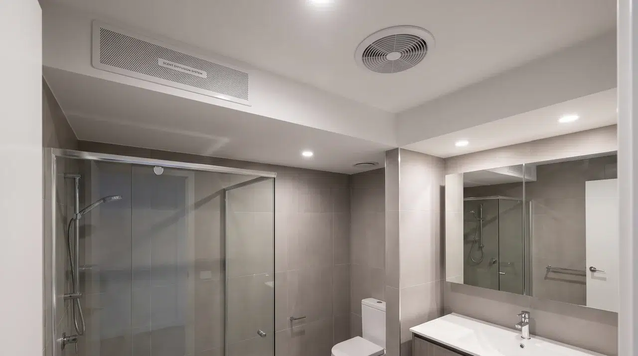 Full bathroom with a built-in scent diffuser system positioned apart from the exhaust vent.