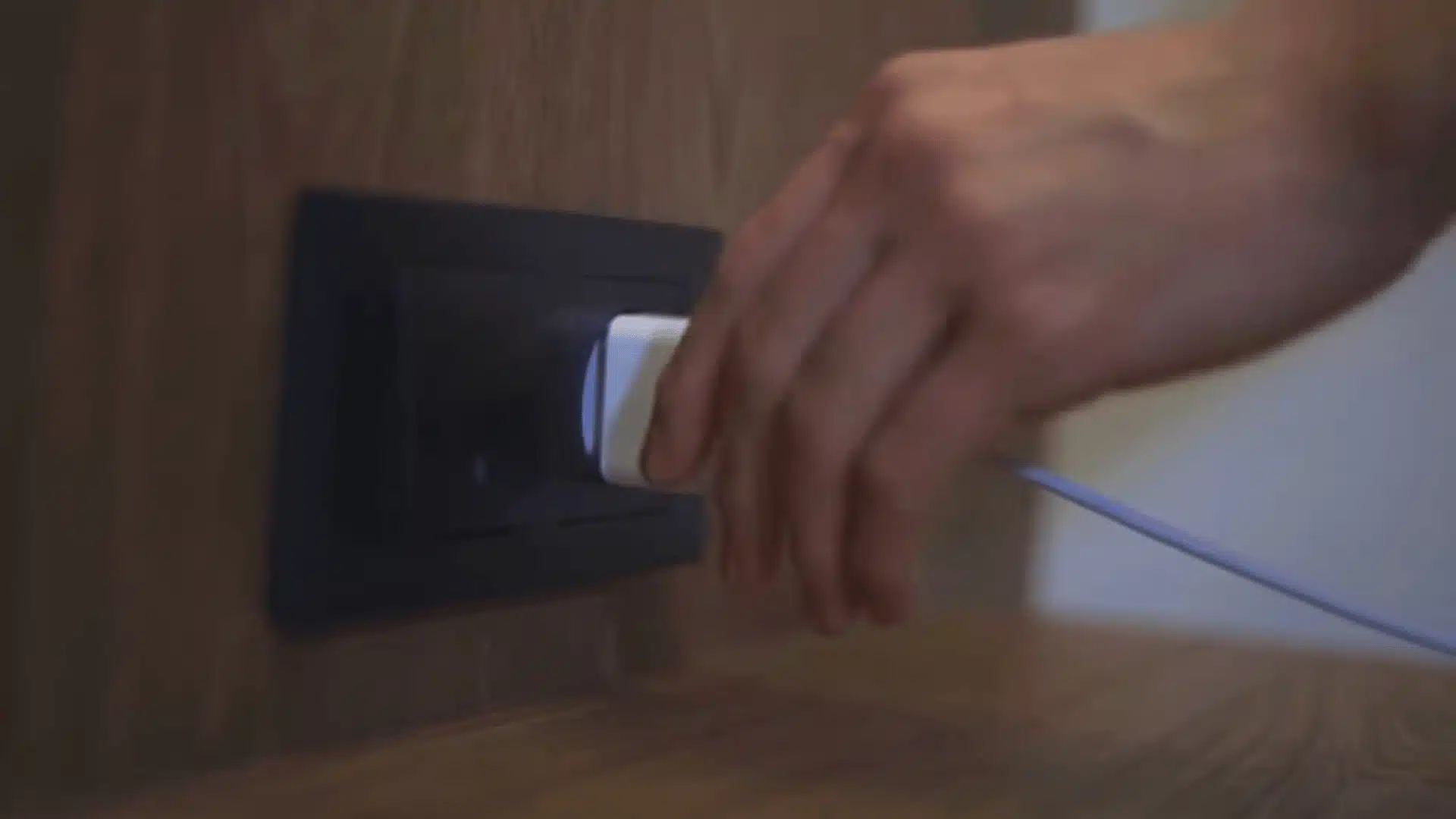 Hand unplugging Alexa Echo power cable from outlet to restart and reset the device.