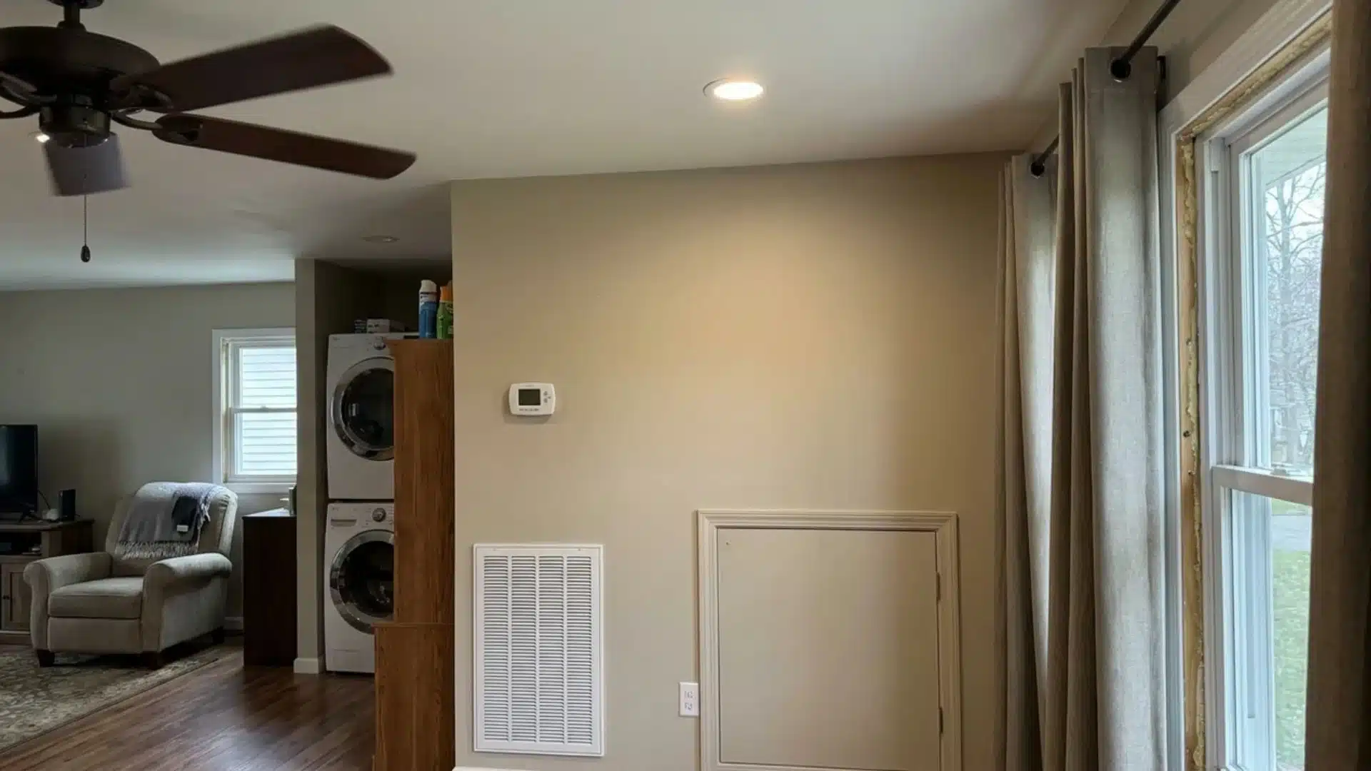 Home with a thermostat, ceiling fan, HVAC vent and efficient appliances for saving energy