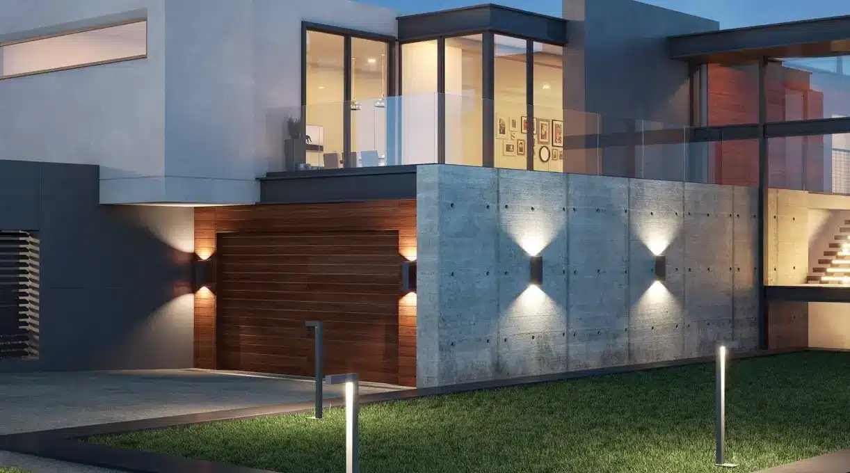 Modern house exterior with concrete and wooden facade under evening lighting