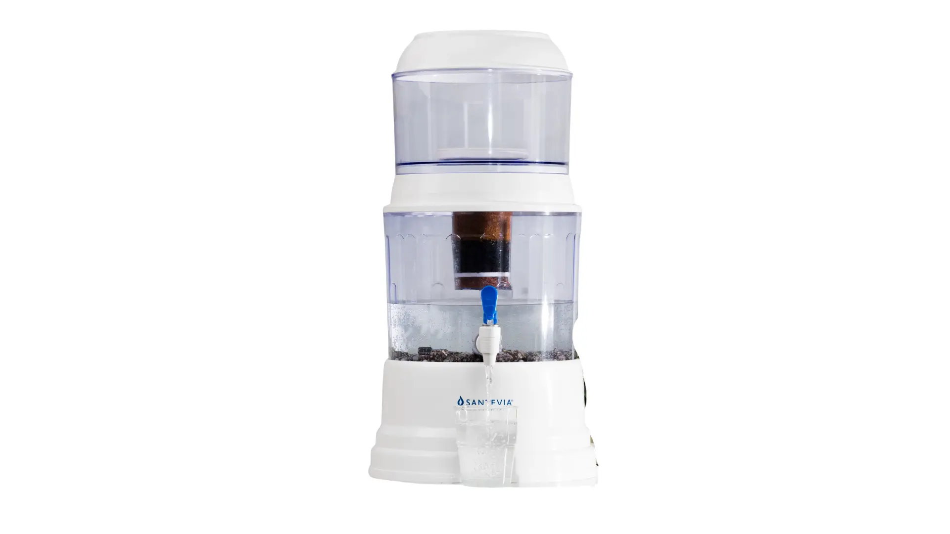 Santevia gravity water filter system dispensing mineral-enhanced filtered water into a glass on a kitchen countertop