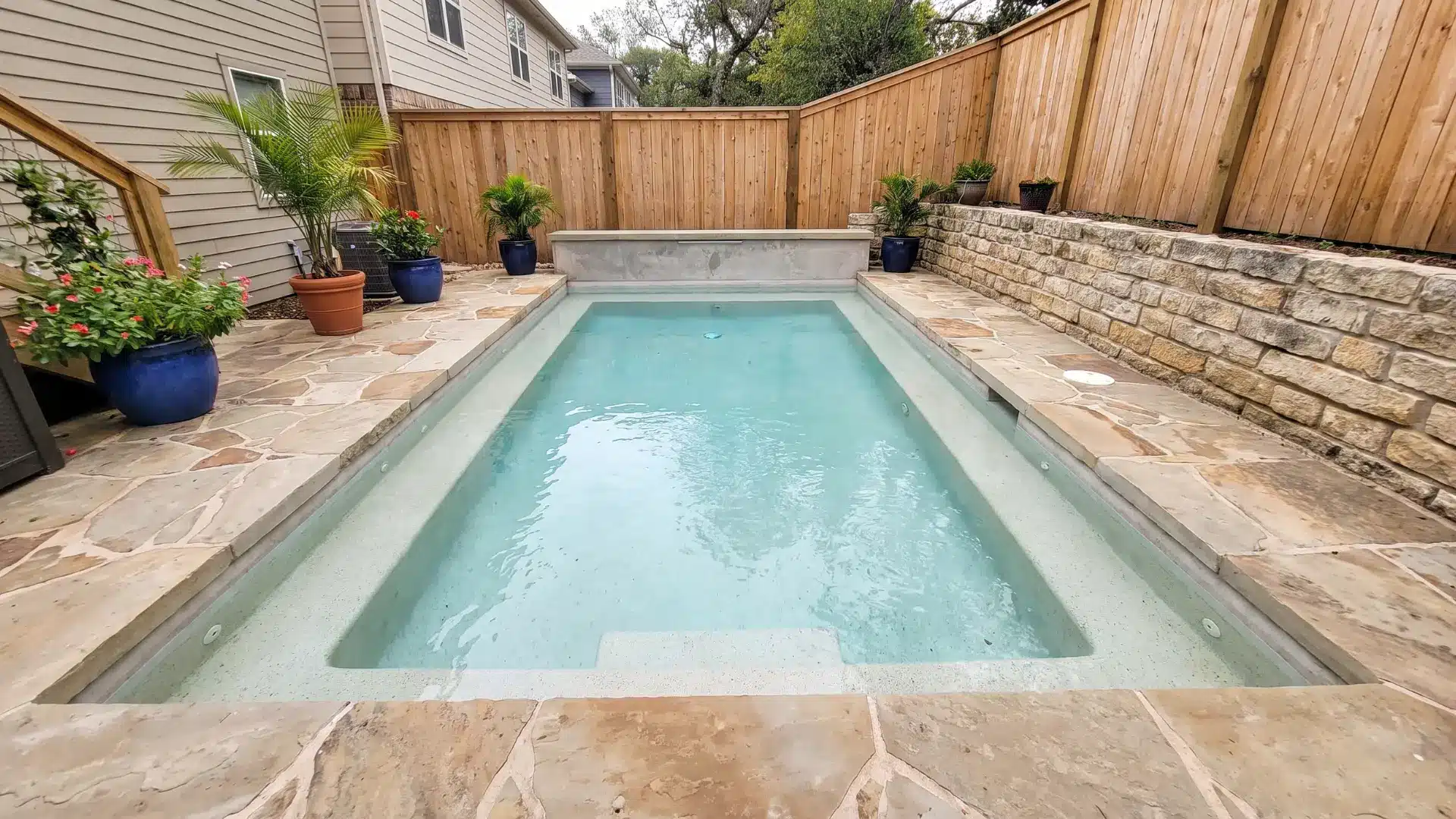 Shallow cocktail pool with built-in seating ledges