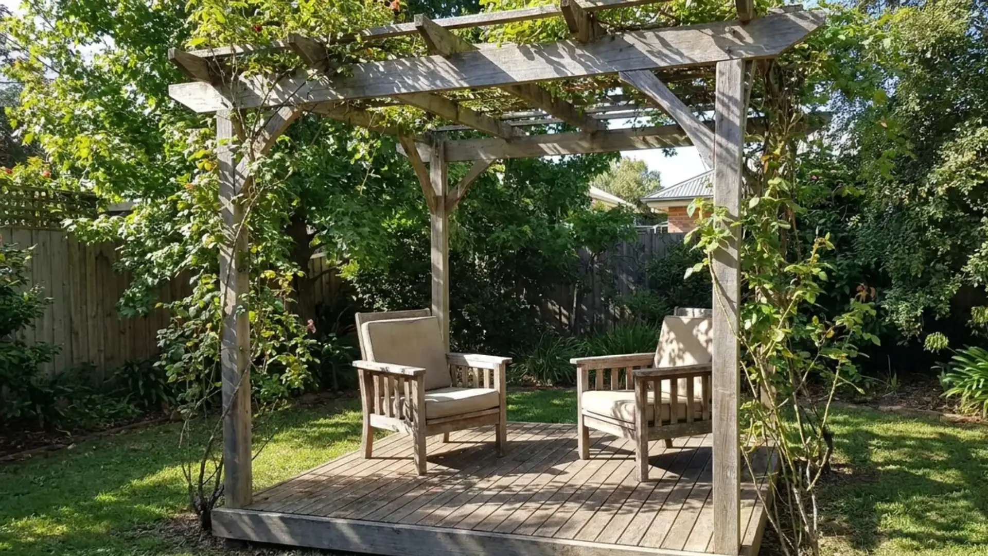 Small wood pergola over seating area on a compact backyard deck