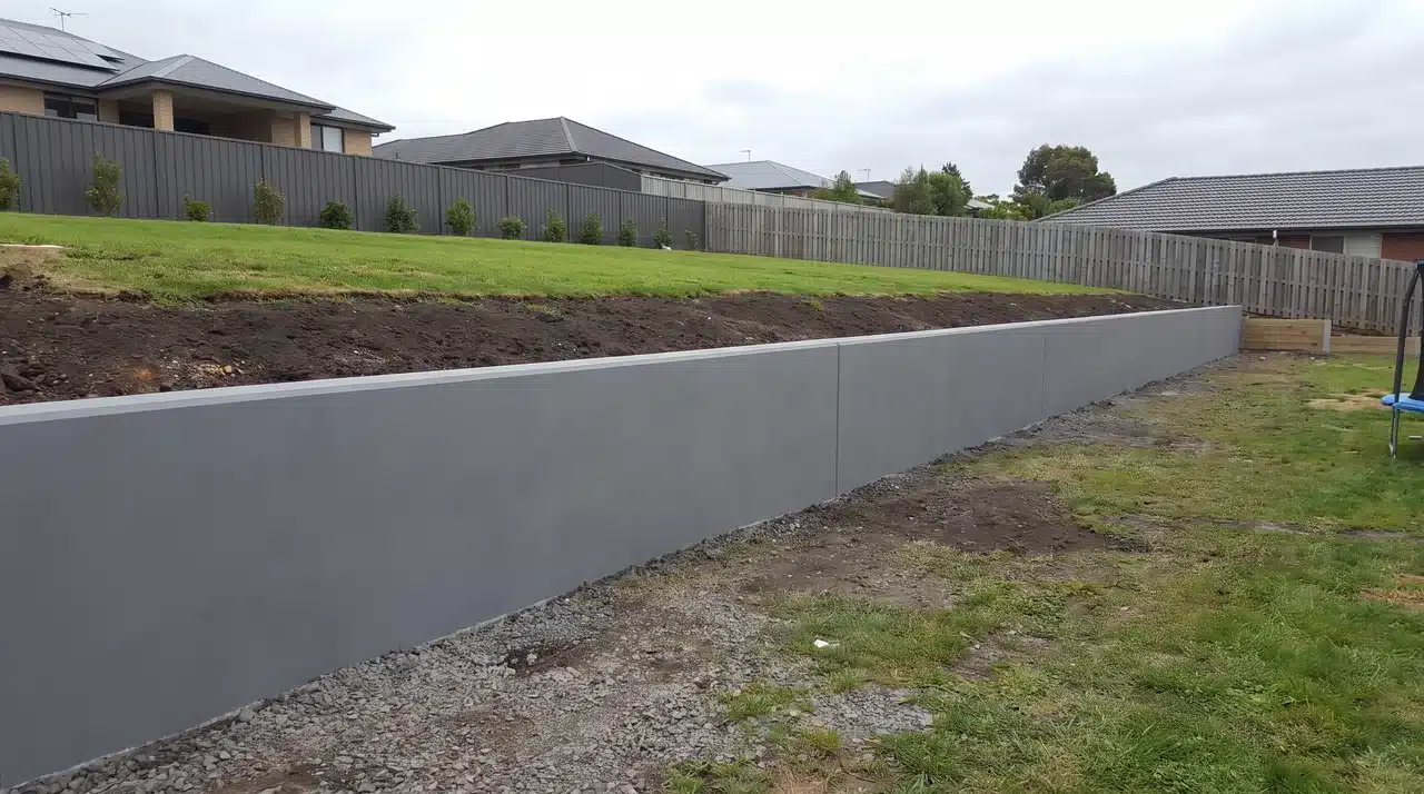 Smooth concrete retaining wall with straight lines and a flat wall face