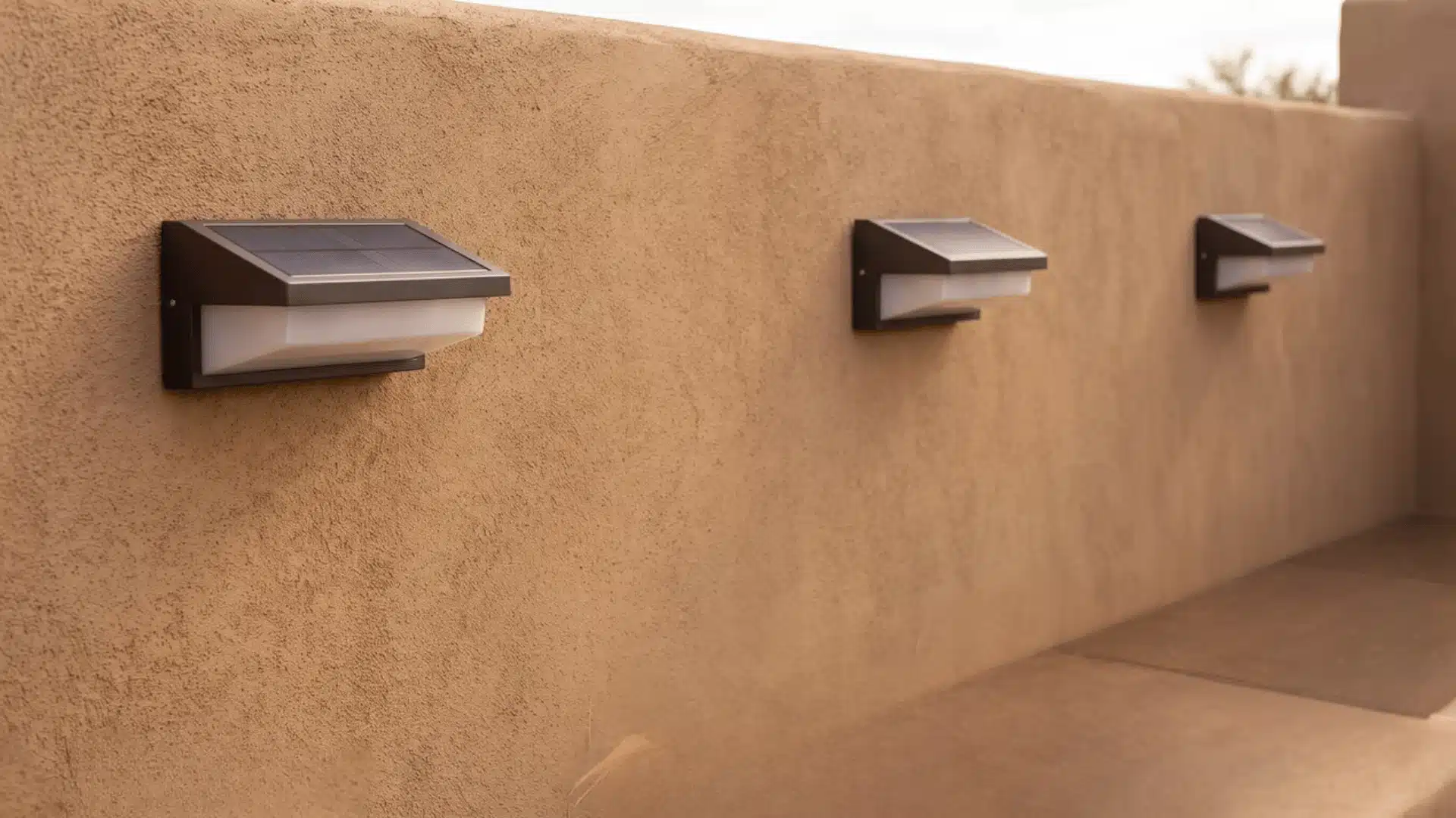 Solar sconces mounted on an exterior wall exposed to direct sunlight