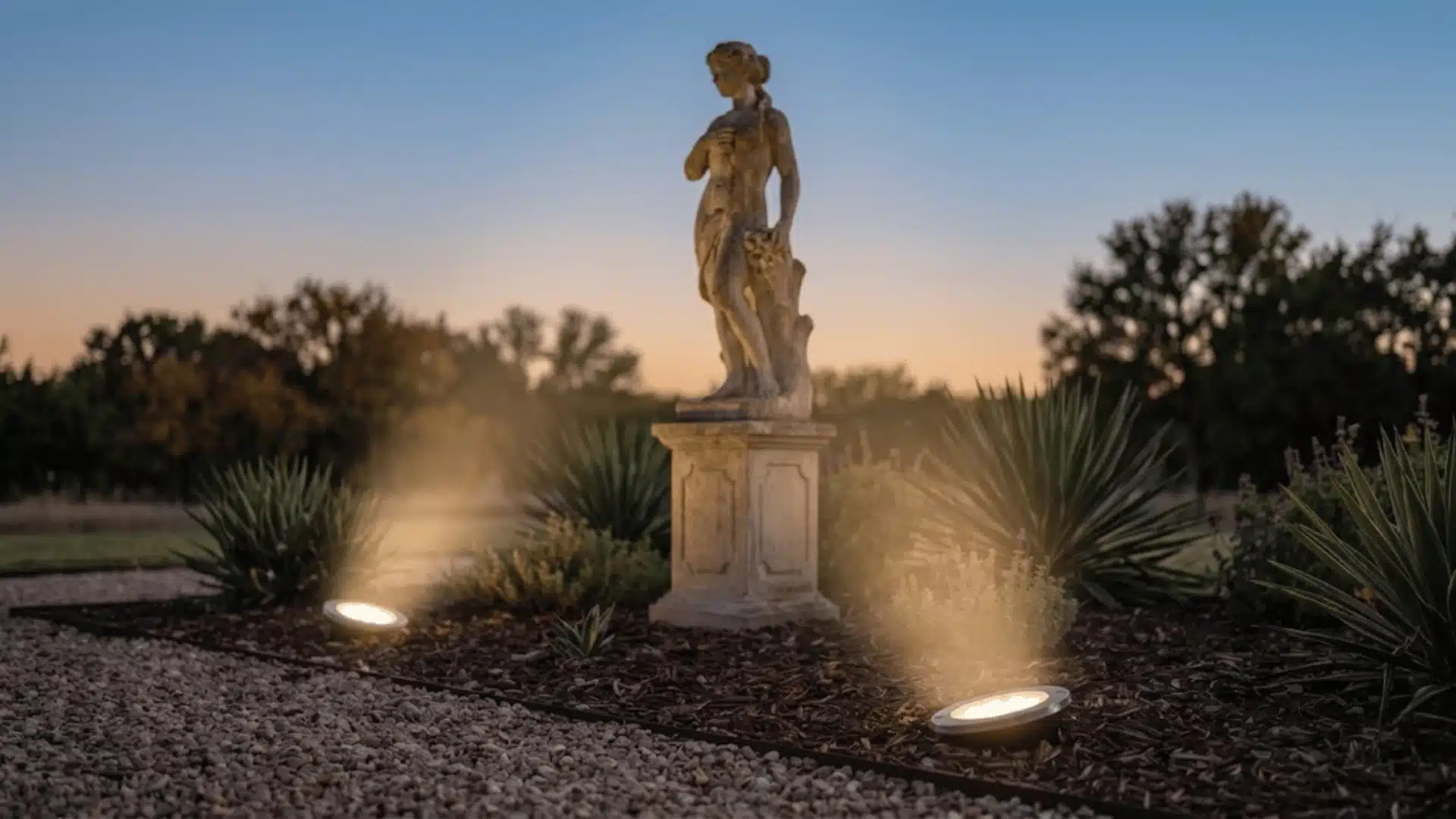 Two solar spotlights aimed upward at a tall outdoor feature from different angles