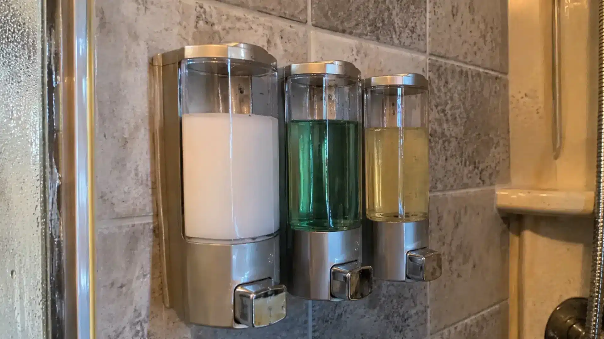 Wall-mounted soap and shampoo dispensers in an rv shower