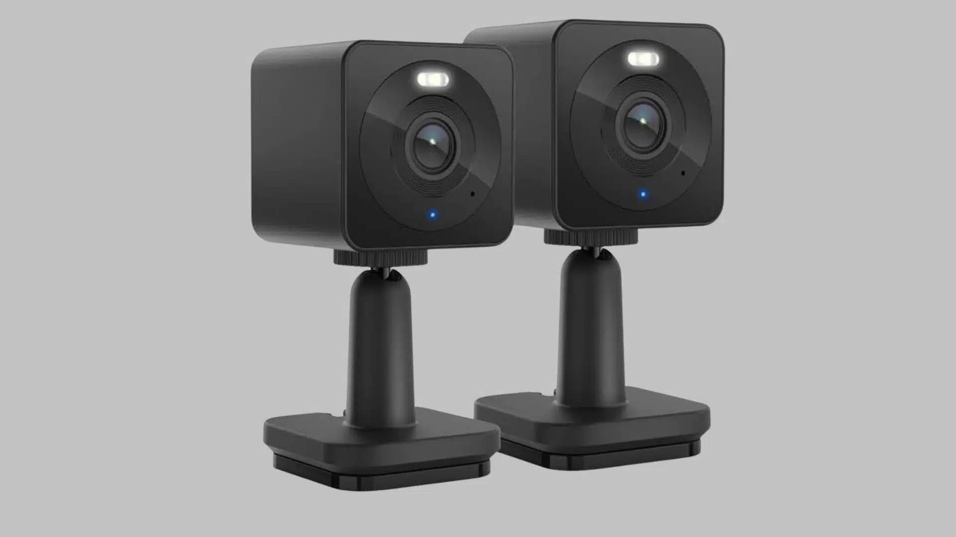 Black Wyze security cameras with square bodies, circular lenses, and adjustable tabletop stands.