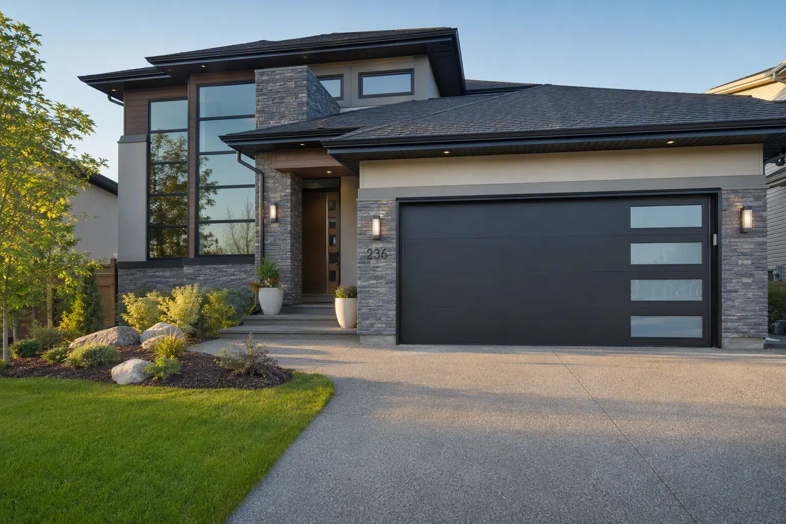 Modern two-story house with stone facade and attached garage in well-maintained suburban setting