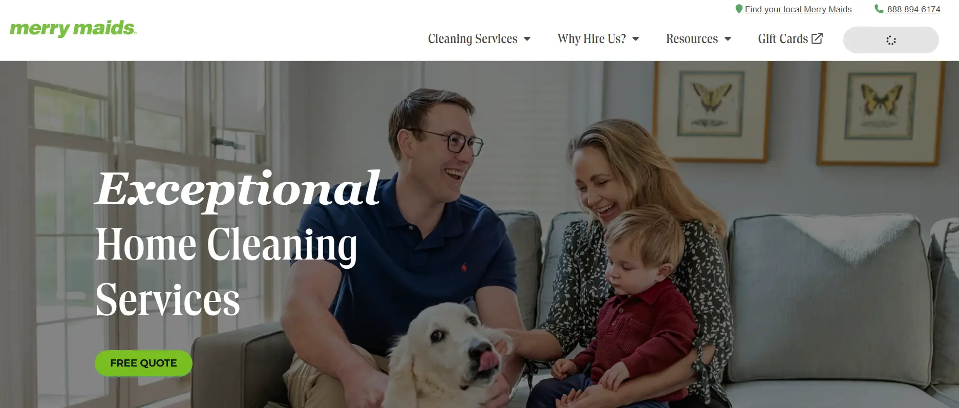 Family sitting on a sofa with a dog in a bright living room