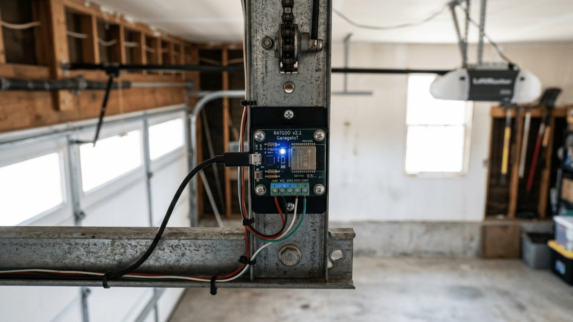 ratgdo smart garage controller mounted to an opener rail with visible wiring and connection terminals