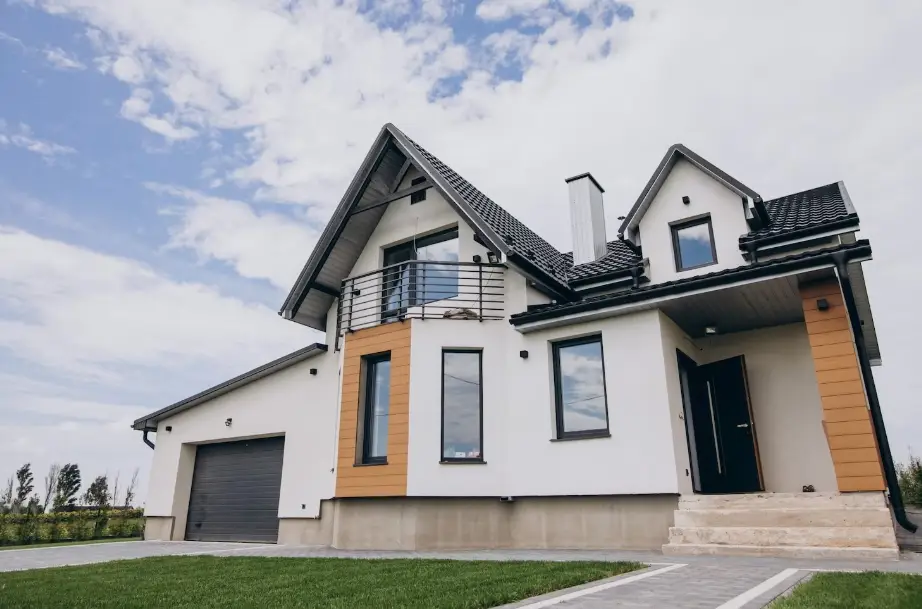 Modern two-story house with sloped roof and garage under cloudy sky