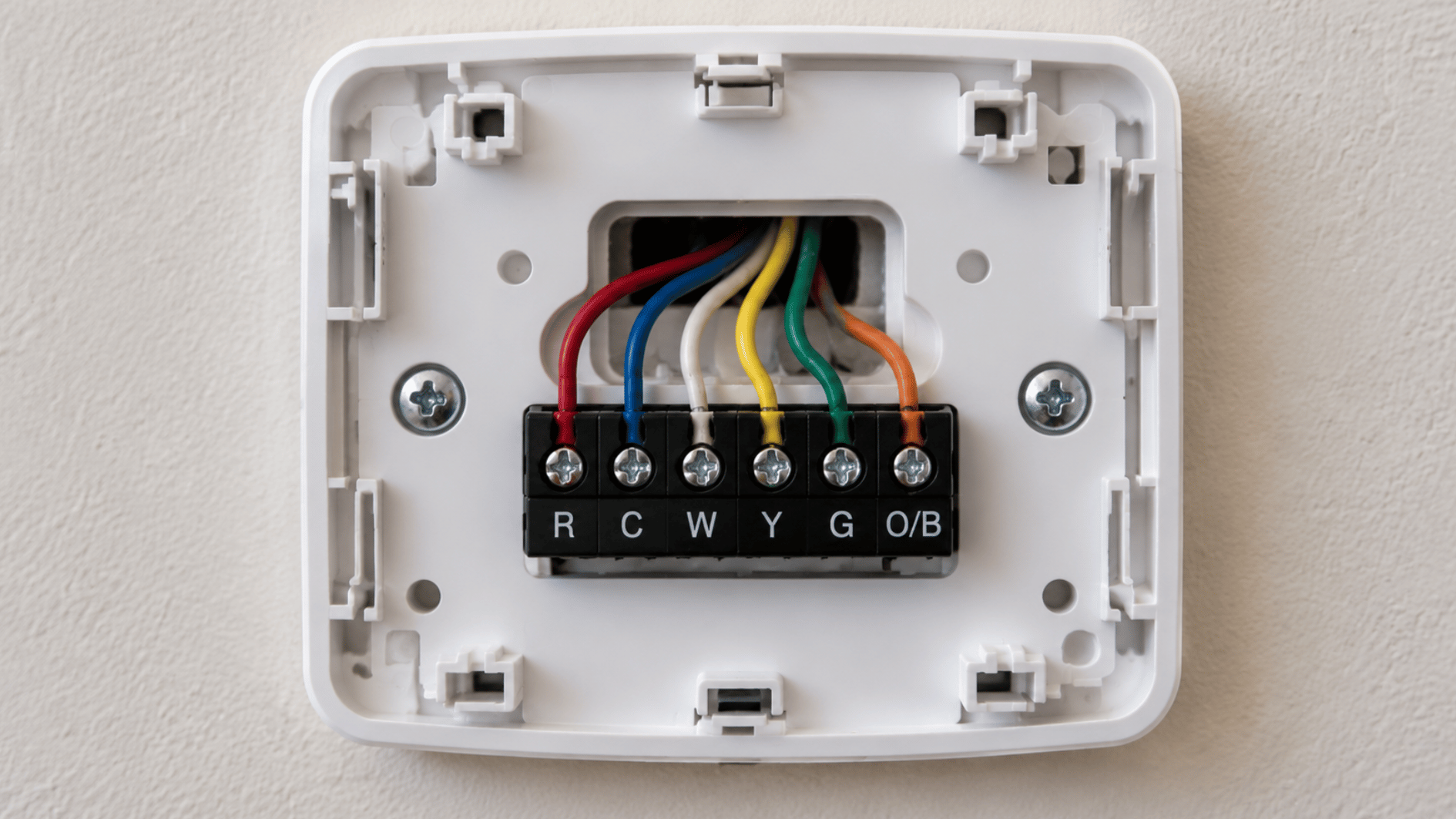 close up view of thermostat base showing C wire and HVAC terminal connections