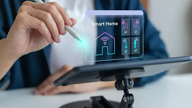 Person using stylus on tablet with smart home interface in modern setting
